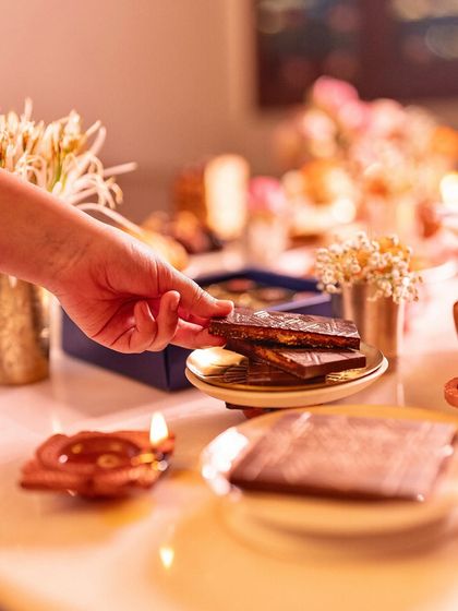 Our Bombay Kaju Krunchy Bar on a festive table, ready to be shared. The intricate design makes it a beautiful addition to any spread.