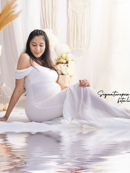 A creative shot with a water reflection effect, adding an artistic and dreamy quality to this boho-styled portrait.