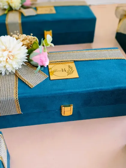 A full view of the premium suede box, showcasing the combination of textures: soft suede, rustic ribbon, and delicate flowers. This is an example of how I create multi-layered, tactile packaging experiences.