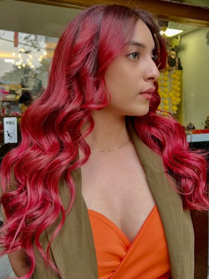 A full head of vibrant magenta waves. This look is pure energy, styled to show off the rich dimension and shine of the custom color.