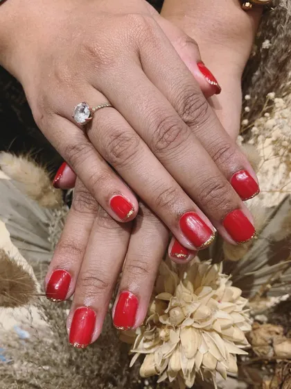 A classic red manicure with a twist. We added a simple, elegant gold line along the cuticle for a subtle touch of glamour.