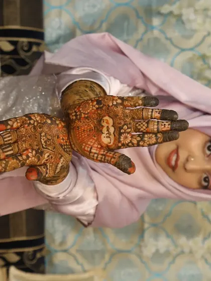 A joyful photo of the bride showcasing her henna on both hands. It was an honor to be a part of her special day.