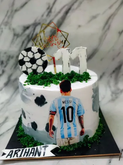 A football theme cake for a Messi fan! This cake is perfect for celebrating a birthday during football season.