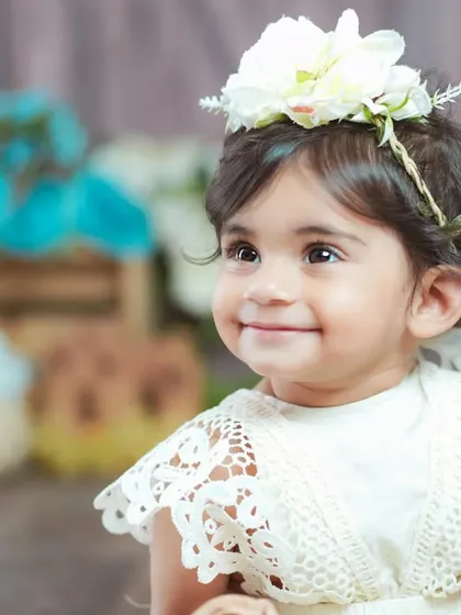 A close-up portrait capturing a sweet, gentle smile. The vintage theme is perfect for these soft and delicate shots.