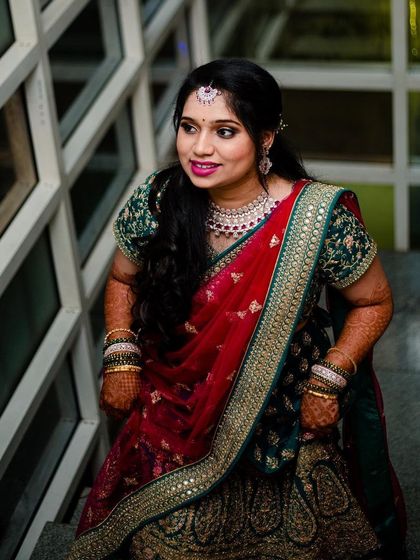 This candid shot on the stairs showcases the full effect of the reception look. The makeup is designed to look beautiful from a distance and in motion, perfect for a night of dancing and celebration.