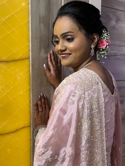 My reception bride Shivani, looking radiant in a soft pink saree. The makeup is dewy and fresh, with a simple yet elegant updo.