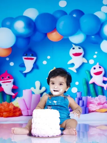 A wide shot of the Baby Shark cake smash, showing the birthday boy and the fantastic underwater-themed decorations.