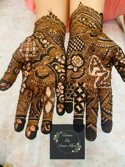 A very dense and intricate design filling the entire palm with a variety of traditional patterns, including checks, florals, and paisleys.