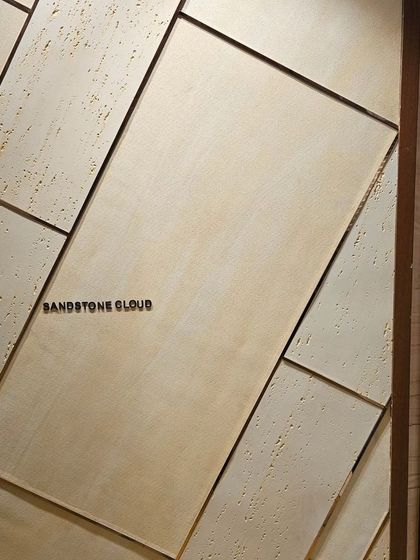 Ittimi panels designed to look like 'Sandstone Cloud'. The geometric arrangement and natural texture create a modern, architectural look.