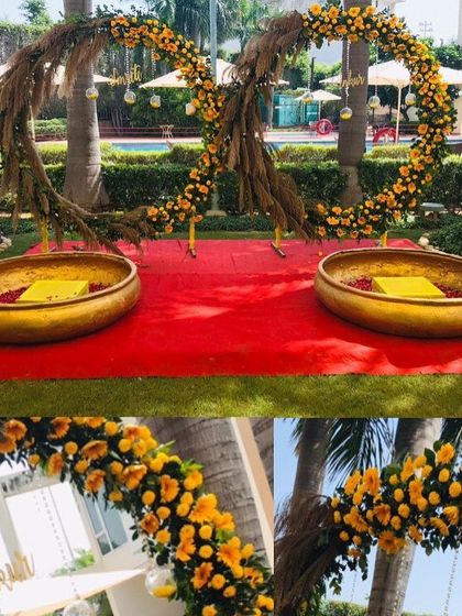 A beautiful Haldi setup with two large circular floral arches made of marigolds, creating a perfect frame for the ceremony.
