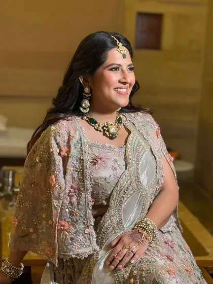 A radiant client ready for a day wedding event at Suryagarh. Her makeup is minimal yet glowing, perfectly complementing her pastel floral lehenga.