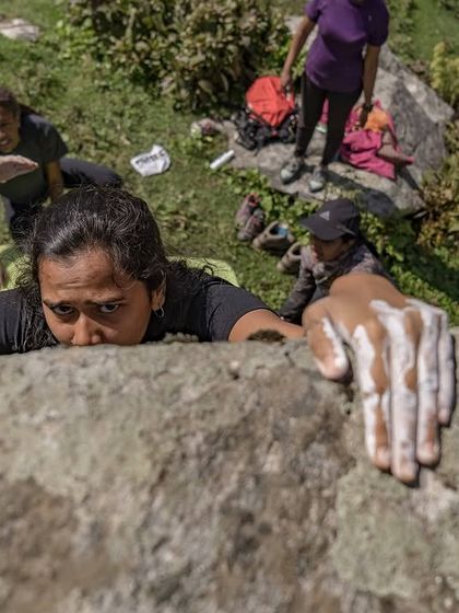 A close-up of a climber's chalky hand as she reaches the top. This image symbolizes the hard work and determination that goes into every climb.