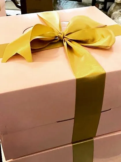 For festivals like Diwali, I prepare these beautiful gift boxes. This one, with its lovely pink box and gold ribbon, is ready to be filled with your choice of my homemade treats to share with loved ones.