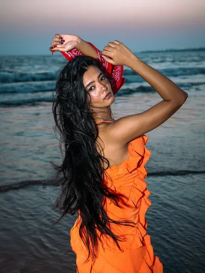 Using the natural beauty of the sea as a backdrop. The movement in the hair and the soft light create a dreamy, aspirational mood for the product.