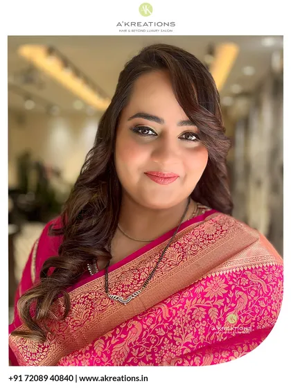 The perfect picture of traditional elegance. This client is glowing with soft, defined makeup and a classic hairstyle that beautifully complements her pink silk saree.