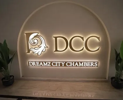 The finished lobby of Dreamz City Chambers, where elegant design welcomes visitors. The illuminated signage and clean material palette create a professional and sophisticated entry point for this commercial building.