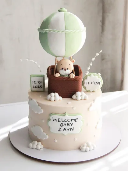 Up, up, and away! Welcoming baby Zayn with this dreamy hot air balloon cake, personalized with his birth date and time.