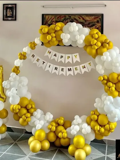 I help companies celebrate important milestones like retirements. This setup features a full circular balloon frame in white and gold, a "Happy Retirement" banner, and large foil number balloons to mark the years of service.
