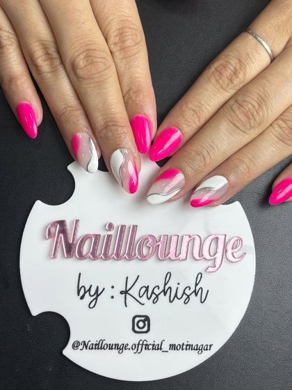 A vibrant pink set with white and silver marble-effect accent nails.