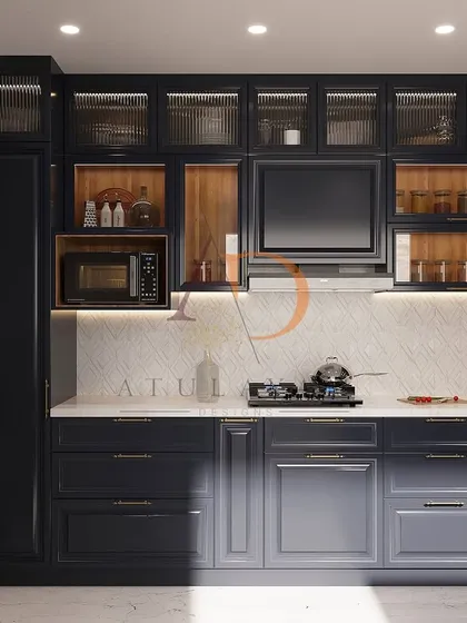 This U-shaped modular kitchen combines rich navy blue cabinetry with warm wood tones. The design includes a built-in microwave and a concealed chimney for a sleek look.
