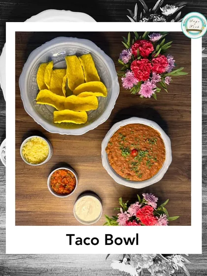 A delicious Taco Bowl platter. This deconstructed taco experience comes with crispy taco shells, a savory bean filling, and all the fresh toppings.