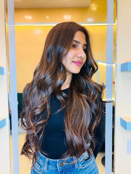 A gorgeous blend of soft gold with chocolate brown. This look is perfect for a glamorous hair makeover, adding warmth and dimension with soft, cascading waves.