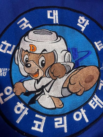 A close-up of a Taekwondo patch from one of our uniforms. This symbol represents our connection to the global Taekwondo community.