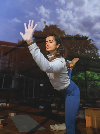 A creative shot of Natarajasana (Dancer's Pose) during the Sthiram retreat, blending the practice with the beautiful surroundings.