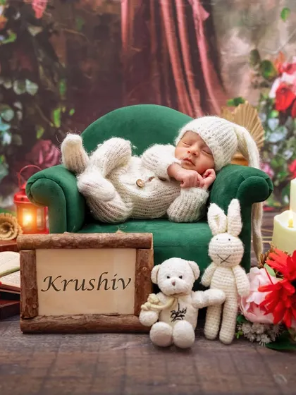 A personalized newborn setup with baby Krushiv's name, featuring him sleeping peacefully on a miniature sofa.