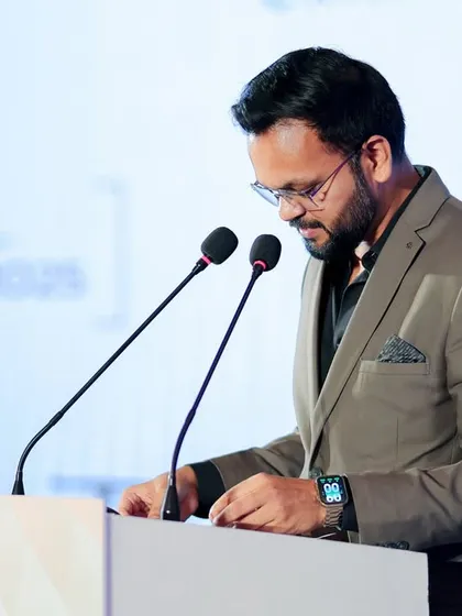 Focused on the script during a formal corporate show. Preparation is key to a flawless event, and I make sure every detail is covered before I step onto the stage.