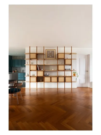 This modular shelving unit in teak and birch ply adds a dynamic display element, with movable boxes that can be reconfigured as the client collects new objects.