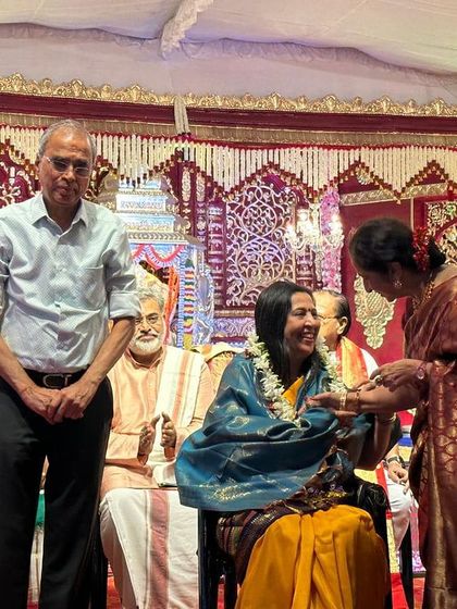 Being draped with a shawl as a mark of respect during the award ceremony. These traditional gestures of honor are a cherished part of our culture.