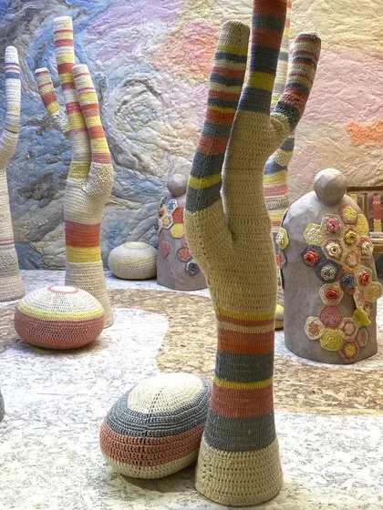 A closer look at the crocheted cacti from the 'Hope You're Well' installation. The pastel stripes and soft texture transform the typically spiky plant into an object of comfort.
