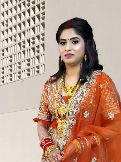 A stunning bridal portrait. The makeup is kept classic and elegant to let the bride's natural beauty and her beautiful orange lehenga shine.