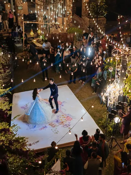 An aerial view of the couple's first dance, showing the entire sangeet setup and guests watching from all around.