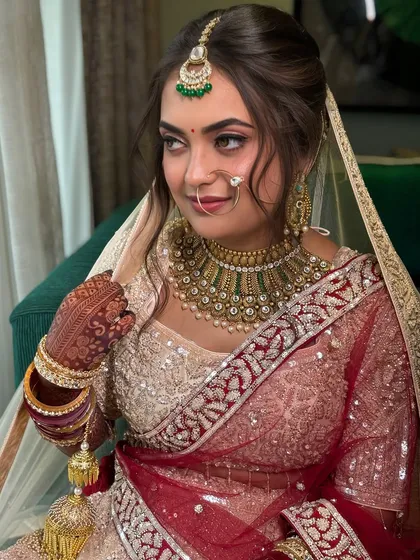 A beautiful portrait highlighting the intricate details of the hairstyle and the way it complements her matha patti.