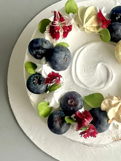 A closer look at the fresh blueberry topping on my Blueberry Naked Cake. I pair the berries with edible flowers and light meringues for a simple, elegant finish.