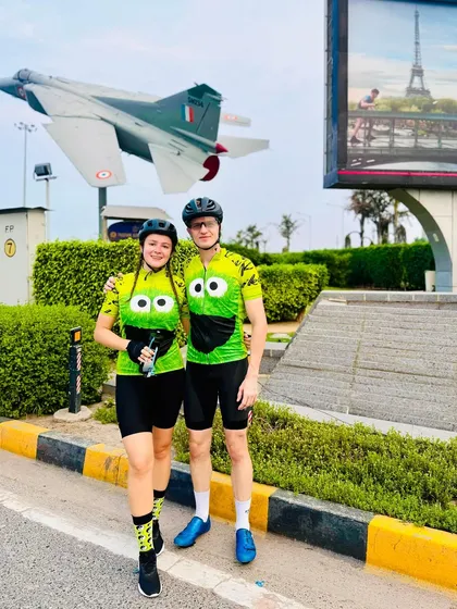 The couple posing together near a fighter jet monument.