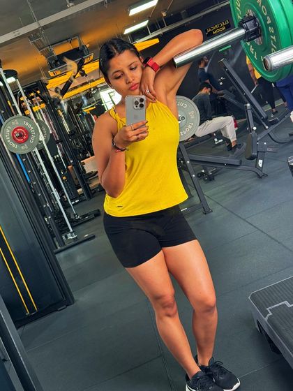 Leaning against a barbell rack after a tough workout. This is the satisfying feeling of giving your all during a training session.