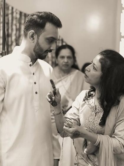 A candid black and white moment of a serious conversation during the festivities.