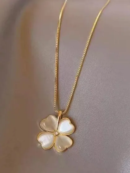 Another view of the mother-of-pearl clover necklace, showing how the delicate box chain complements the luminous pendant.