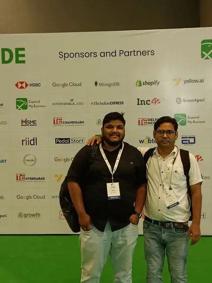 Building strong partnerships is key to success. I'm pictured here with a colleague at the CODE convention, in front of a wall of major sponsors like Google Cloud and Shopify, who are leaders in the digital space.