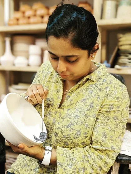 Here I am in my studio, hand-painting a bowl for an upcoming collection. This focused, meticulous work is where each piece gets its unique personality and artistic touch.