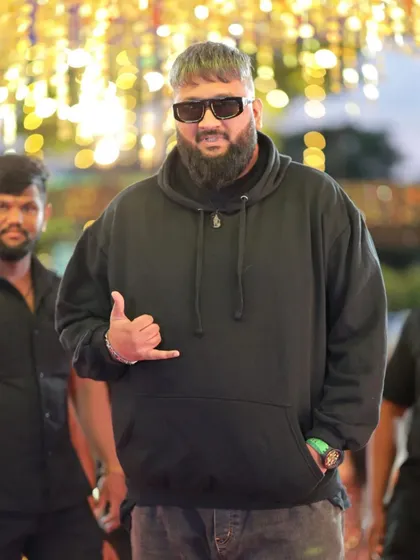 Rapper All OK giving a thumbs-up, captured in a candid moment at the event.