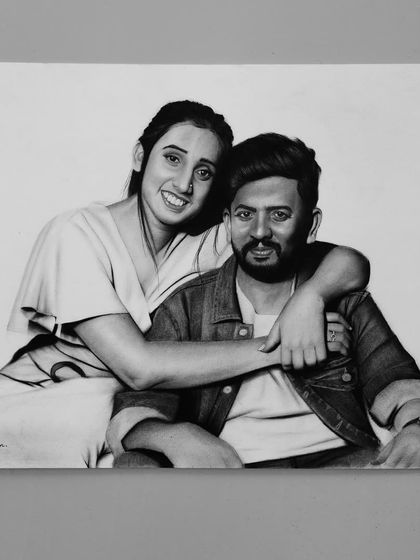 A finished A3 size portrait of a couple in a warm embrace. This piece was created using both graphite and charcoal to achieve a range of tones and textures.