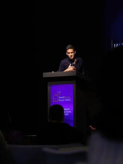 A speaker delivers a presentation during Day 2 of the conference, focusing on immersive AV and smart security solutions.