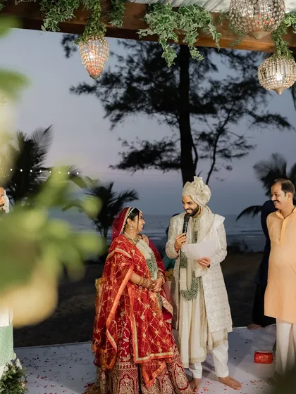 Sometimes you can almost hear a photograph. Here, the groom shares his vows, a memory of a lifetime created at a beautiful beachside ceremony as the sun sets.
