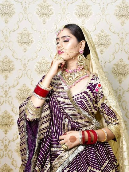 A student's work showcasing a traditional Rajasthani bridal look. We encourage students to explore regional bridal styles to broaden their skill set.