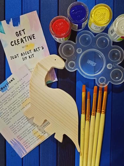 Here is everything you get in one of our DIY kits: a wooden cutout, paints, brushes, a palette, and instructions. It's a complete art experience in a box.