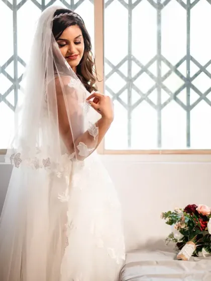 A lovely, soft-lit bridal portrait by the window, just after getting ready.